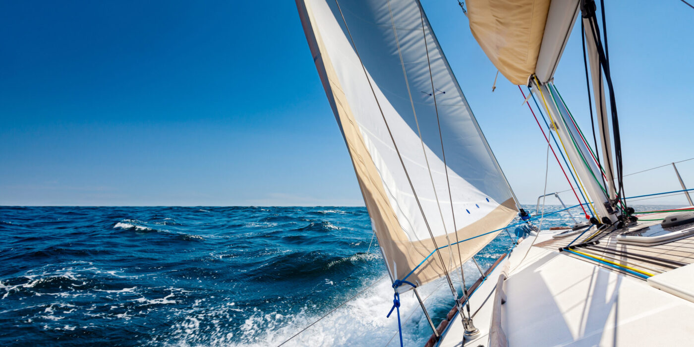 Sailing lboat at open sea in sunshine
